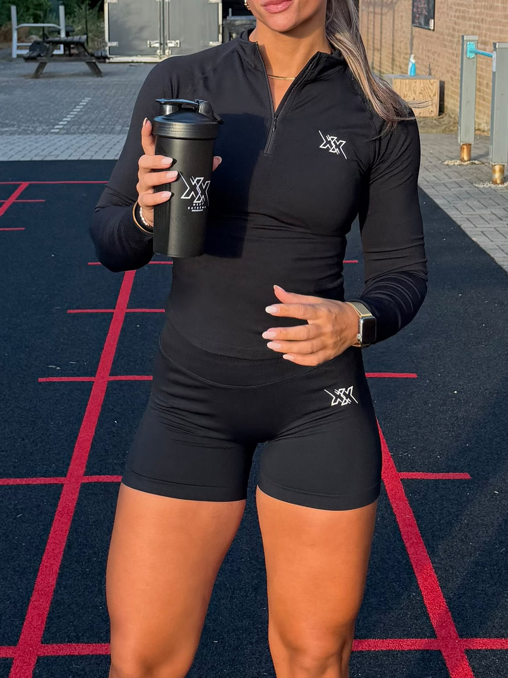 Atlete in de Crop Zipper en Shorts 4.5 inch in Ultra Black van Next Extreme met shaker op de baan
